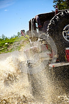 Big Jeep splashing mud in the mountains #3