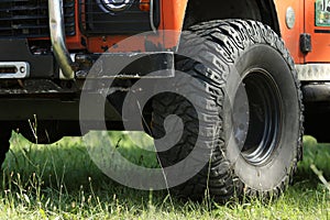 Big jeeps wheel on a grass