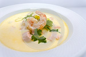 Big king prawn in shrimp cream soup with parsley and lemon