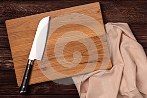 Big kitchen knife laying on a cutting board