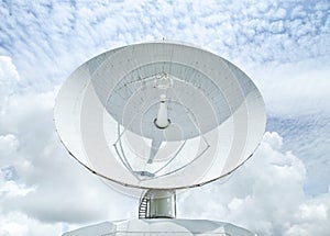 Big large white satellite dishe turn up skyward on blue sky