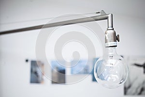 Big light bulb hanging from a metal pipe