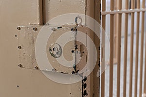 Big lock on prison door with bars