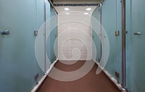 Big lockers with a wood bench in a locker room with doors closed