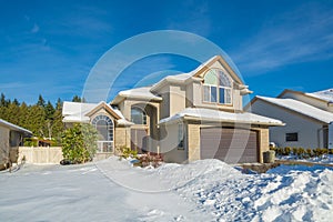 Big luxury house with front yard in snow