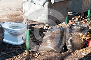 Big metal dumpster garbage cans full of overflow litter polluting the street in the city, environmental concept