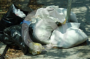 Big metal dumpster garbage cans full of overflow litter polluting the street in the city, environmental concept