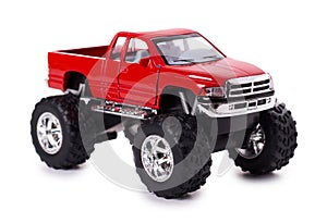 Big metal red toy car offroad with monster wheels isolated on white background