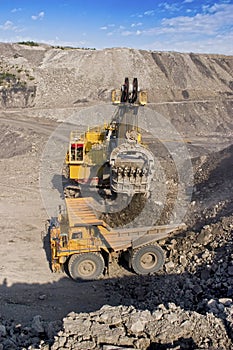 Big mining truck and excavator