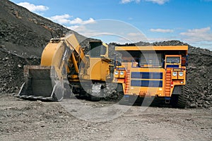 Big mining truck and excavator