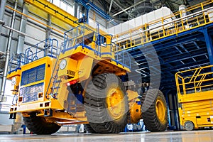 Big mining truck in the production shop of the car factory.