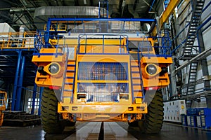 Big mining truck in the production shop of the car factory.