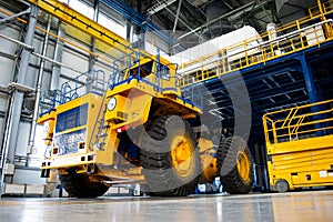 Big mining truck in the production shop of the car factory.