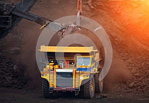 Big mining truck unload coal in coal mine