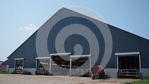 Big modern cow shed on agricultural rural ranch. Exterior livestock facility