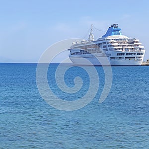 Big modern luxury cruise ship docked at marina dock with sea photo