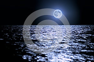 Big moon over the sea at night. moonlight on the waves, horizon. Long exposure