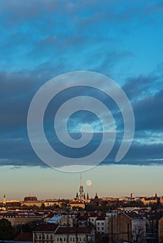 Big moon over the town with blue sky and clouds