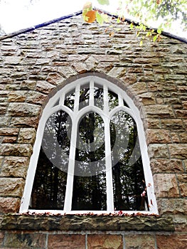 Big Moose historic granite Chapel with ornate gothic windowpane