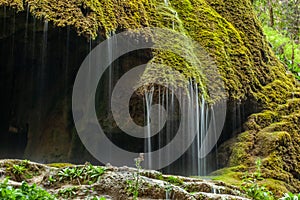 Big moss and waterfall in dark forest.