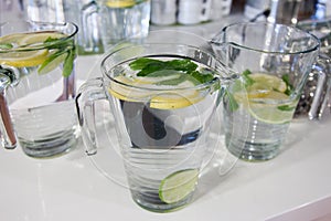 Big mugs of fresh water with lemon