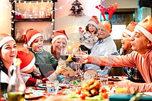 Big multi generation family toasting at christmas dinner feast - Winter holiday x mas concept with parents and children