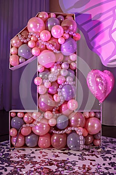 Big number one of the pink color baloons for children`s birthday. Birthday party