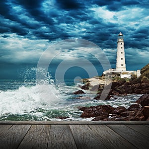 Big ocean wave, lighthouse and wood pier