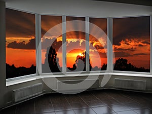 Big office windows with sunset beyond it