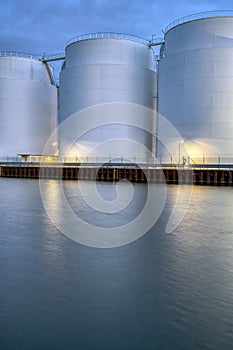 Big oil storage tanks at dusk