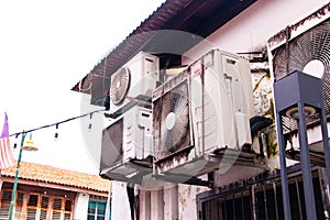 Big old air conditioner compressor source heat pumps. Dust black and rust, oil cling to air conditioner.