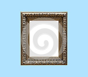 Big old antique golden frame isolated on blue background