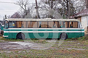 Big old bus is standing on the street in the grass