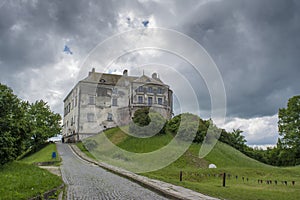 Big old dark ancient castle on the hill in the village not far from Lviv city