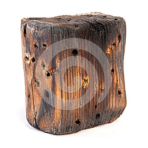 Big old dark cube is cut out from old wood. Isolated on white