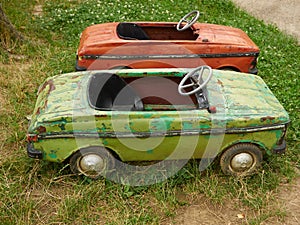 Big old toy cars in summer garden, outdoors