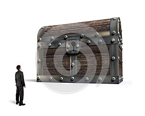 Big old treasure chest with small man looking at