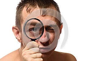 Big open eye. A man holds a magnifier near his face. Search. White background