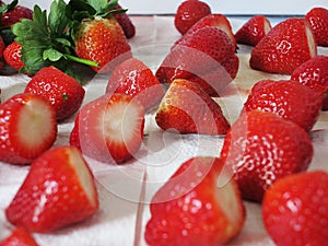 Big organic cut red ripe strawberry's on paper towel.