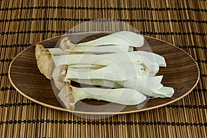 Big Oyster Mushroom (Pleurotus Eryngii Mushroom) decorated on plate over wooden background. photo