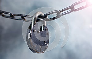 Big padlock hanging on a thick chain