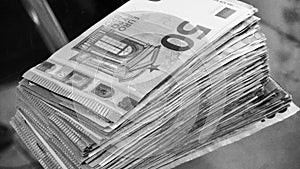 Big paper money pile of 50 euro bills or banknotes. Lots of money. Being rich concept. Black and white photo