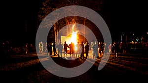 Big party at camp fire at night