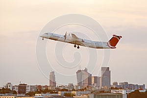 The big passenger plane takes off at the city airport.