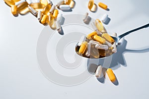Big pharma conspiracy theory. Medical pills lying on spoone