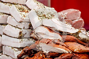 Big pieces of lard or bacon covered with herbs and spices and smoked chicken