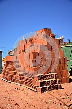 A big pile of Bahia bricks in the sun for building houses in the condominium photo
