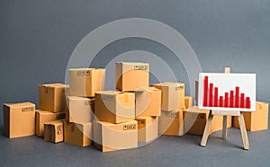 A big pile of cardboard boxes and a stand with information chart. Increasing consumer demand, exports or imports. rate growth