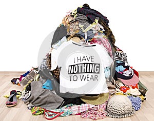 Big pile of clothes thrown on the ground with a t-shirt saying nothing to wear.