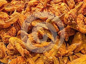 Big pile of deep-fried chicken wings for food background concept